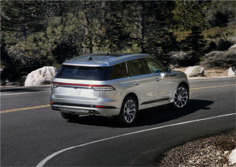 A 2023 Lincoln Aviator® Grand Touring model is shown being driven on a tight turn of a mountain road | Don Franklin Lincoln Elizabethtown in Elizabethtown KY