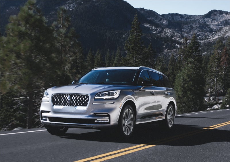 A 2023 Lincoln Aviator® Grand Touring SUV being driven on a winding road to demonstrate the capabilities of all-wheel drive | Don Franklin Lincoln Elizabethtown in Elizabethtown KY