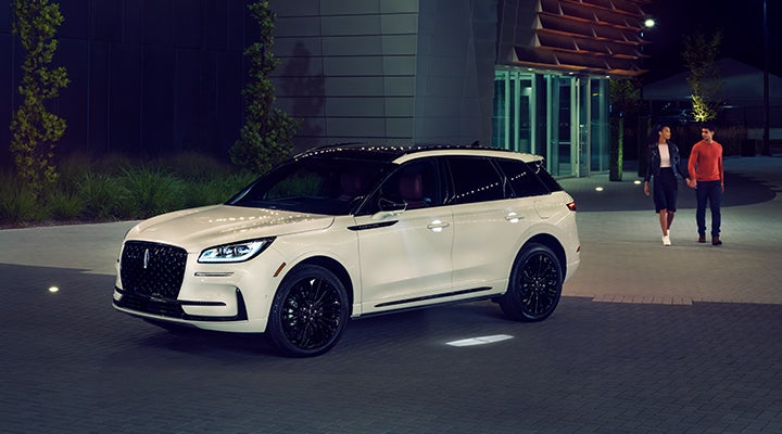 Two people approach a 2024 Lincoln Corsair® SUV featuring the available Jet Appearance Package. | Don Franklin Lincoln Elizabethtown in Elizabethtown KY