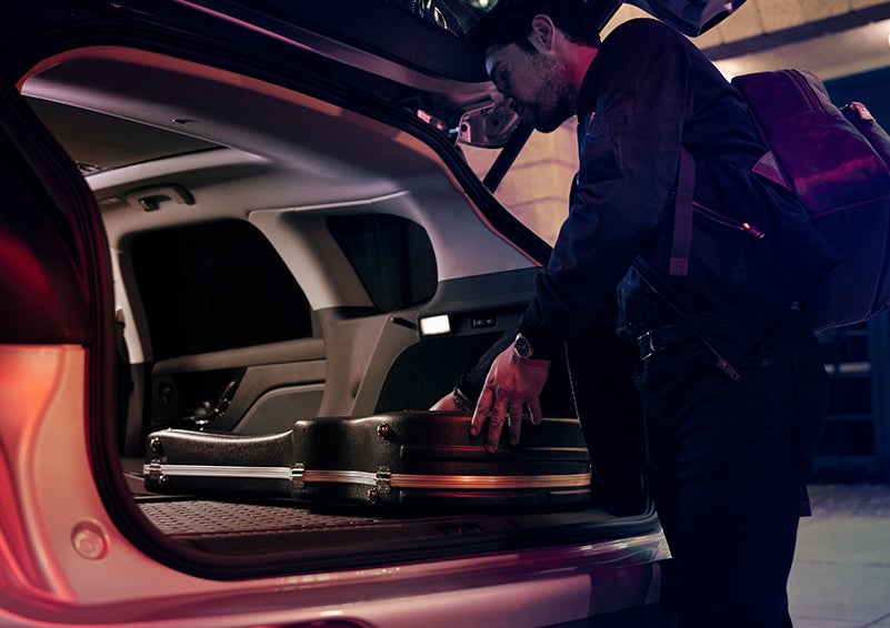 A man is shown loading cargo into the rear of a 2024 Lincoln Corsair® SUV with the second-row seats folded flat. | Don Franklin Lincoln Elizabethtown in Elizabethtown KY