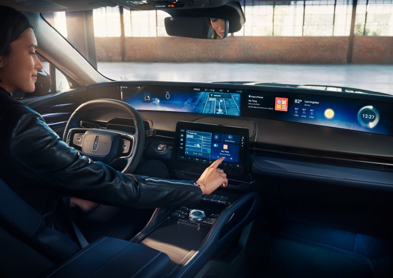 The driver of a 2024 Lincoln Nautilus® SUV interacts with the center touchscreen. | Don Franklin Lincoln Elizabethtown in Elizabethtown KY