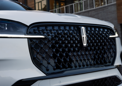 The black grille of a white 2025 Lincoln Aviator® SUV is shown with its fog lights on. | Don Franklin Lincoln Elizabethtown in Elizabethtown KY