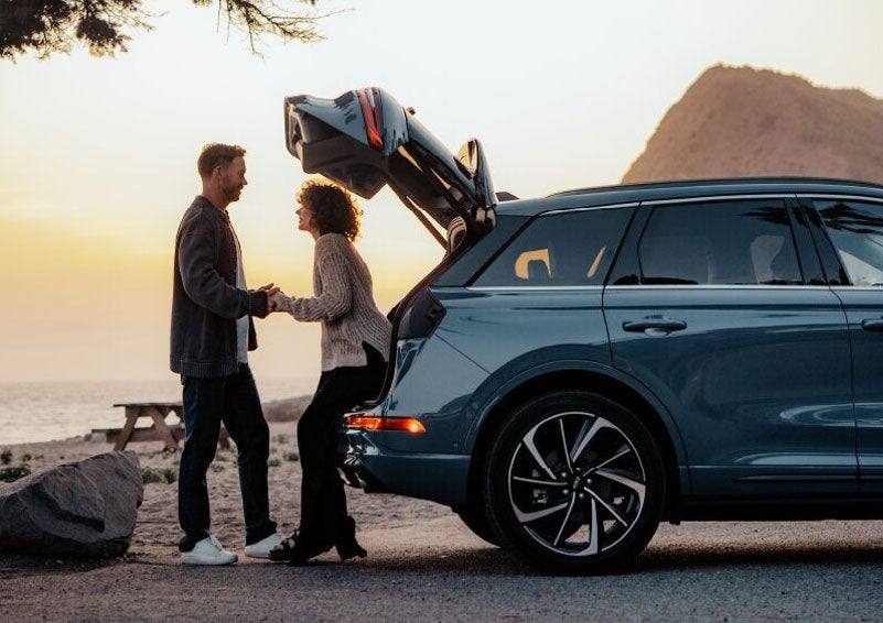 A couple share a moment together outside a 2025 Lincoln Corsair® SUV near the open liftgate. | Don Franklin Lincoln Elizabethtown in Elizabethtown KY