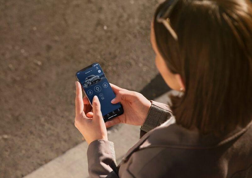 A person is shown interacting with a smartphone to connect to a Lincoln vehicle via the Lincoln Way® App. | Don Franklin Lincoln Elizabethtown in Elizabethtown KY
