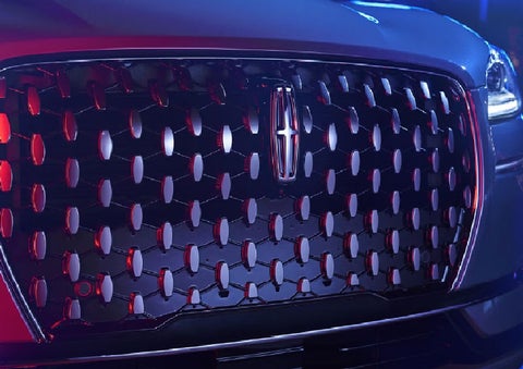 The grille of a 2025 Lincoln Corsair® SUV reflects neon light at night. | Don Franklin Lincoln Elizabethtown in Elizabethtown KY