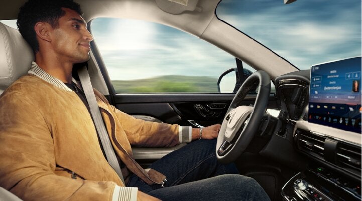 A person is shown using Lincoln BlueCruise hands-free highway driving technology on a divided highway called a Hands-Free Blue Zone. | Don Franklin Lincoln Elizabethtown in Elizabethtown KY