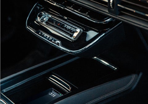 A smartphone is is being placed on the wireless charging pad in the front center console cubby. | Don Franklin Lincoln Elizabethtown in Elizabethtown KY