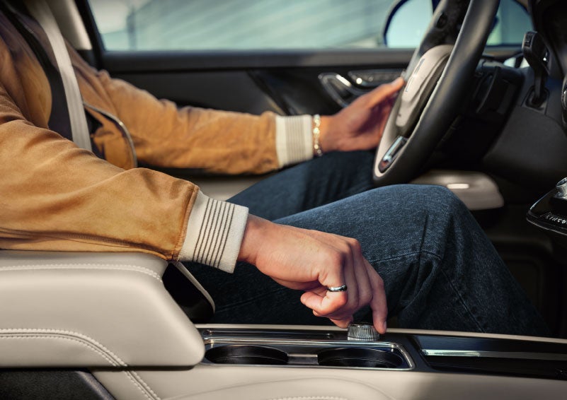 The driver of a 2024 Lincoln Corsair® SUV is shown selecting the drive mode. | Don Franklin Lincoln Elizabethtown in Elizabethtown KY