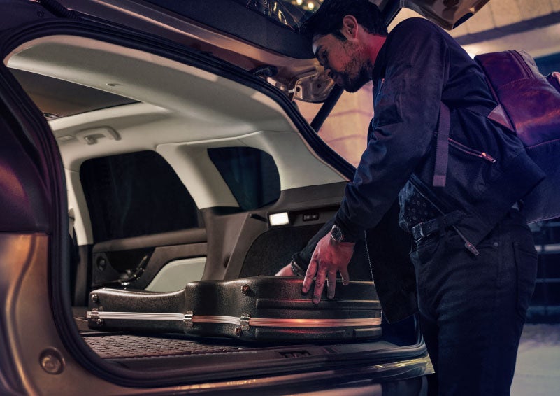 A man is shown loading cargo into the rear of a 2024 Lincoln Corsair® SUV with the second-row seats folded flat. | Don Franklin Lincoln Elizabethtown in Elizabethtown KY