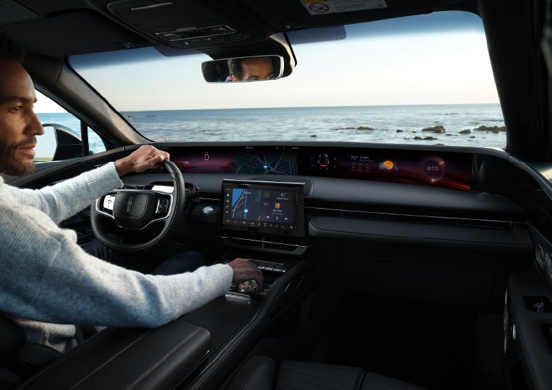A driver of a parked 2025 Lincoln Nautilus® SUV takes a relaxing moment at a seaside overlook while inside his Nautilus. | Don Franklin Lincoln Elizabethtown in Elizabethtown KY