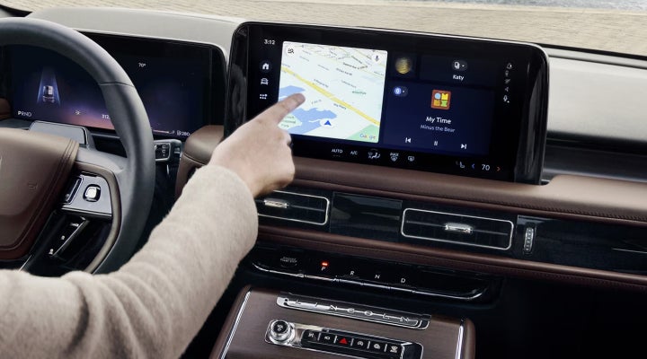 A person is tapping the center display touchscreen of a 2026 Lincoln Aviator® SUV. | Don Franklin Lincoln Elizabethtown in Elizabethtown KY