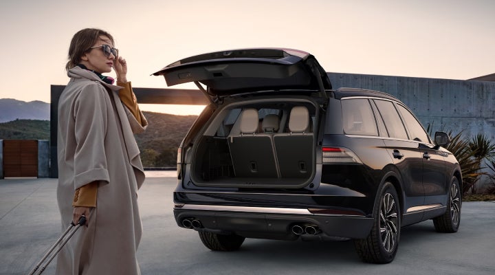 A woman approaches a 2026 Lincoln Aviator® SUV with its rear liftgate open. | Don Franklin Lincoln Elizabethtown in Elizabethtown KY