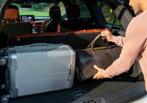 A man loads luggage into the rear of a 2026 Lincoln Aviator® SUV through the opened rear liftgate. | Don Franklin Lincoln Elizabethtown in Elizabethtown KY