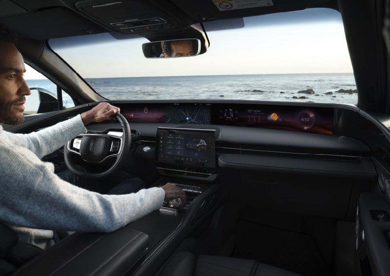 A driver of a parked 2026 Lincoln Nautilus® SUV takes a relaxing moment at a seaside overlook while inside his Nautilus. | Don Franklin Lincoln Elizabethtown in Elizabethtown KY