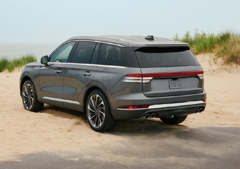 A 2027 Lincoln Aviator® SUV is parked next to sand dunes. | Don Franklin Lincoln Elizabethtown in Elizabethtown KY