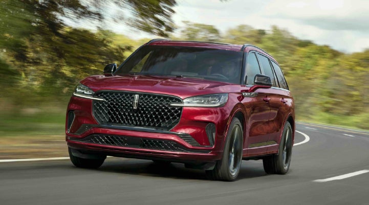 A 2027 Lincoln Aviator® SUV is being driven on a country road | Don Franklin Lincoln Elizabethtown in Elizabethtown KY