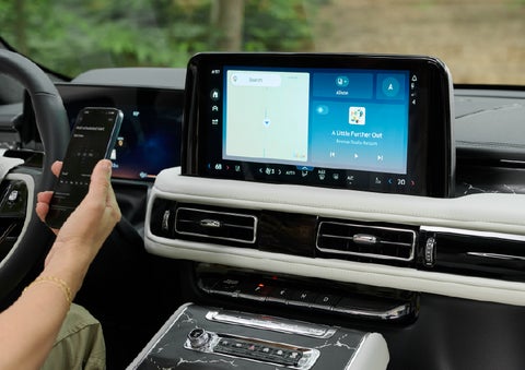 A person pairs thier phone with the center touchscreen of a 2027 Lincoln Aviator® Black Label™ SUV | Don Franklin Lincoln Elizabethtown in Elizabethtown KY